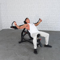 Thumbnail for Man in white tank top and light pants using a black incline pec fly machine.