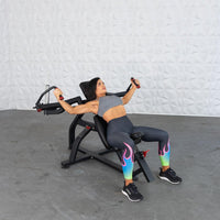 Thumbnail for Woman using an incline pec fly machine, engaging her chest muscles.