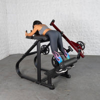 Thumbnail for Woman on a plate-loaded reverse hyper machine with an adjustable roller pad.