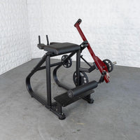 Thumbnail for Black and red plate-loaded reverse hyper machine with an adjustable roller pad and weight plates.