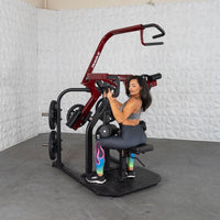 Thumbnail for Woman using a red and black plate-loaded rotary lat pull-down machine.