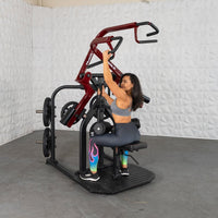 Thumbnail for Woman using a red and black rotary lat pull-down machine with plate weights.