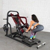 Thumbnail for Woman using a red and black chest-supported row machine with weights.