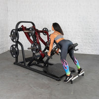 Thumbnail for Woman using a chest-supported plate-loaded row machine with weight plates.