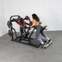 Thumbnail for Woman using a chest-supported plate-loaded row machine with red arms and black weight plates.