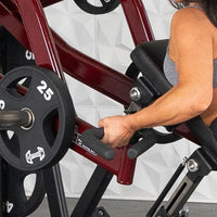 Thumbnail for Woman using a chest-supported row machine with 25lb weight plates.