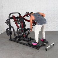 Thumbnail for Man using a red and black plate-loaded chest-supported row machine in a gym.