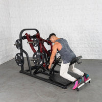 Thumbnail for Man using a red and black chest-supported plate-loaded row machine in a gym.