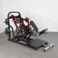 Thumbnail for Red and black plate-loaded chest-supported row machine with weight plates on a gray floor.