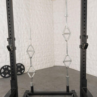 Thumbnail for Black squat stand with J-hooks, two multi-grip pull-up bars, and two 45lb weight plates on the floor.