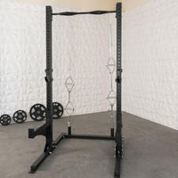 Thumbnail for Black squat stand with pull-up bar, safety spotters, weight plate holders, and four weight plates.