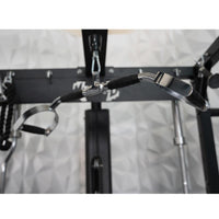 Thumbnail for Close-up of a lat pulldown bar attached to a black fitness machine, with a white textured wall in the background.