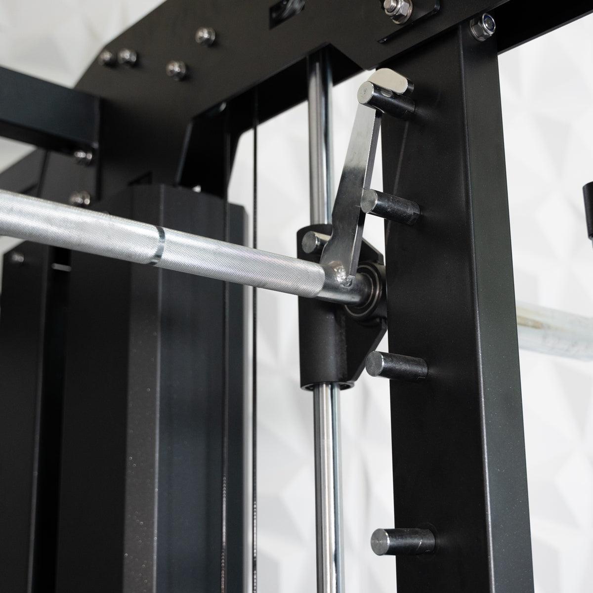 Close-up of a silver barbell on a black weight machine, showing the locking mechanism and safety pins.