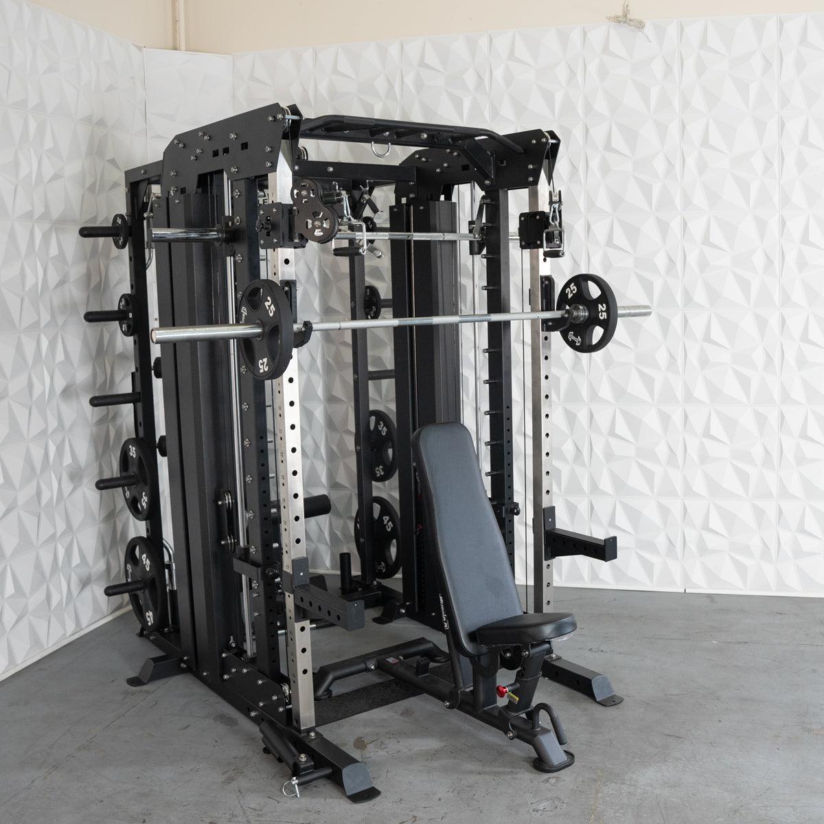 Black and silver multi-station home gym with a barbell, weight plates, and an adjustable bench.