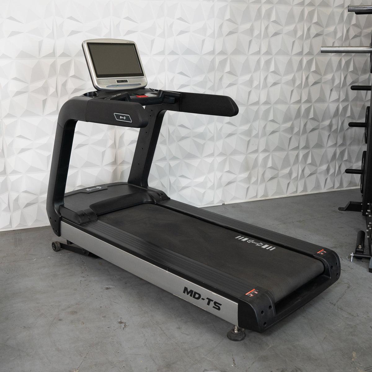 Black and silver commercial treadmill with a large touchscreen display.