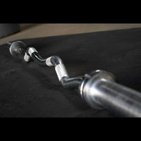 Thumbnail for Hard chrome curl bar with ergonomic angles on a dark surface.