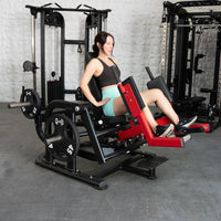 Thumbnail for Woman using a black and red plate-loaded abductor/hip extension machine in a gym.