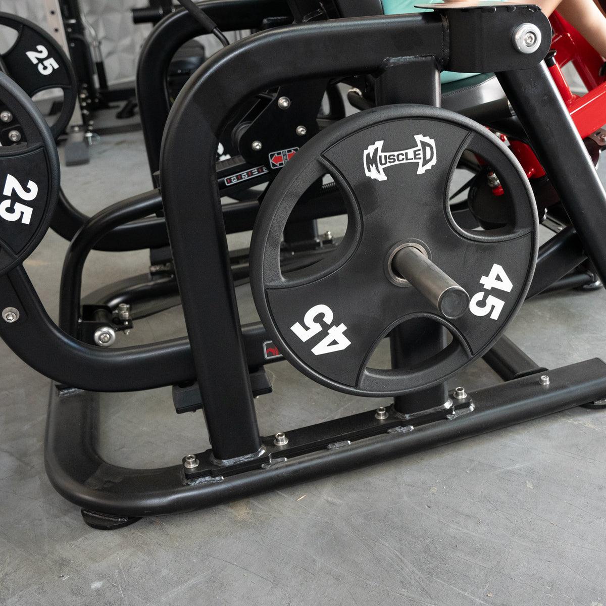 Close-up of a black plate-loaded fitness machine with a 45lb weight plate attached.