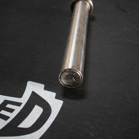 Thumbnail for Close-up of the end of a stainless steel Olympic bar with a silver end cap and 