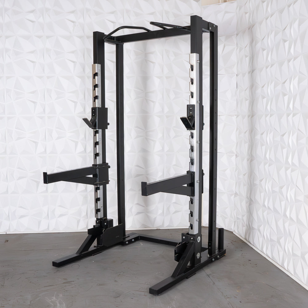 Black half rack with adjustable safety bars and pull-up bar.