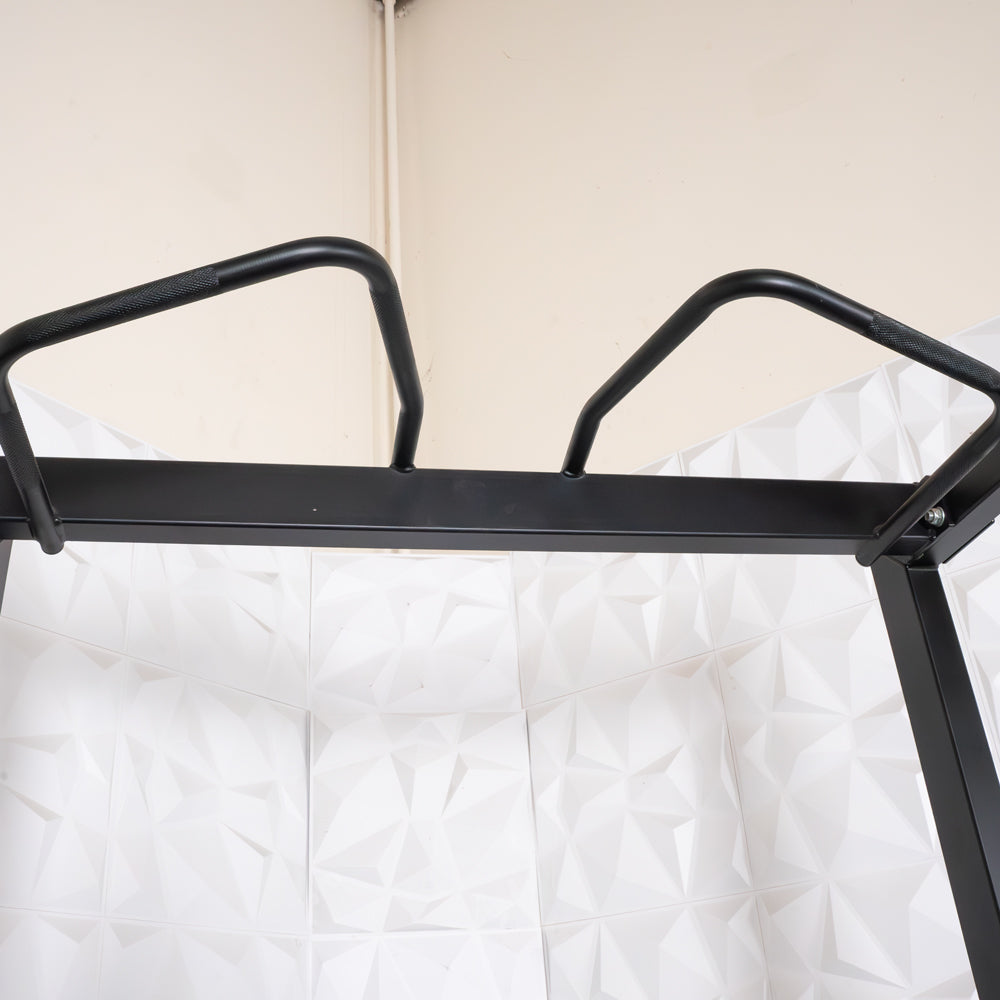 Close-up of the black pull-up bar with angled grips on the half rack.