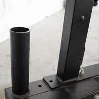 Thumbnail for Close-up of the black vertical Olympic bar storage tube on the half rack base.