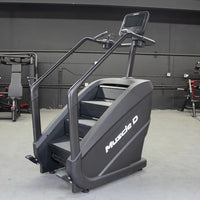 Thumbnail for Black Muscle D Fitness stair climber with a touchscreen display and handrails in a gym setting.