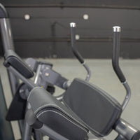 Thumbnail for Close-up of a gray ab crunch machine with padded armrests and handles.