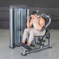 Thumbnail for Man using an ab crunch machine with a weight stack in a gym.