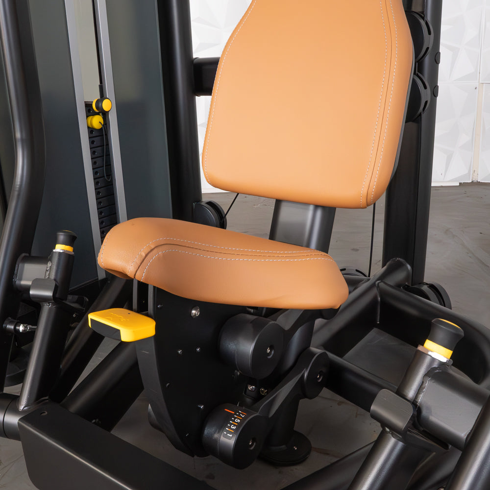 Close-up of a commercial chest press machine with tan padded seats and black frame.