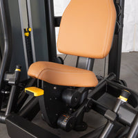 Thumbnail for Close-up of a commercial chest press machine with tan padded seats and black frame.