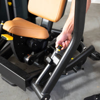 Thumbnail for Hand adjusting the seat of a black and tan commercial chest press machine.