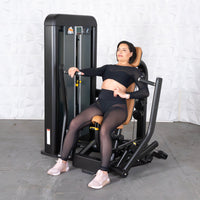 Thumbnail for Woman in black activewear on a black and tan chest press machine.