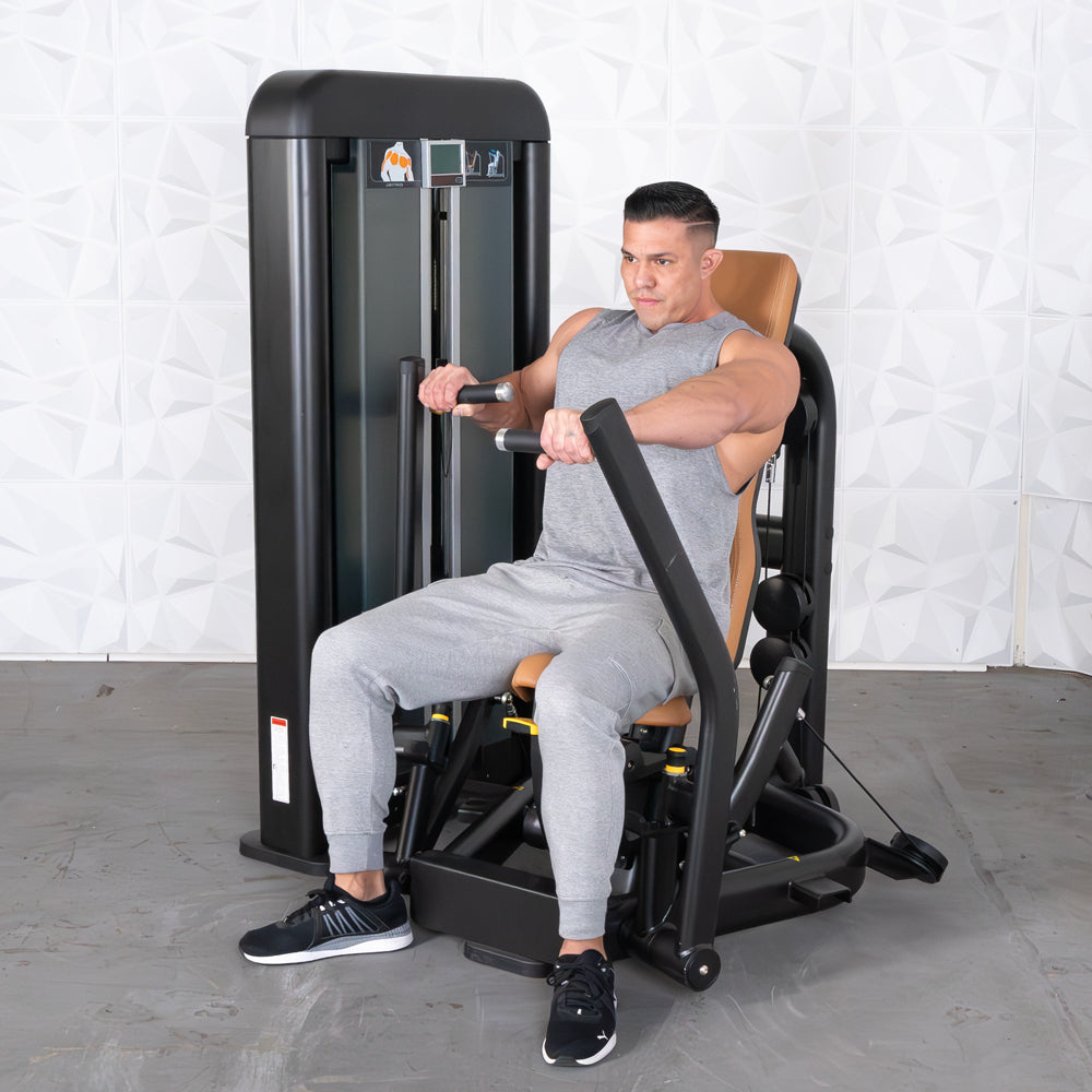 Man in gray tank top and sweatpants using a black and brown chest press machine.