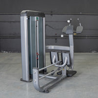 Thumbnail for Gray commercial glute blaster machine with black padded armrests and footplates against a dark wall.