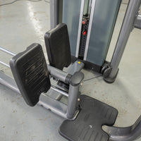 Thumbnail for Close-up of a gray gym machine with black footrests and a weight stack in the background.