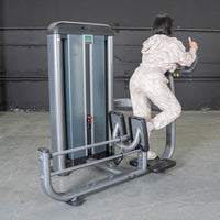Thumbnail for Woman using a gray glute blaster machine in a gym.