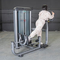 Thumbnail for Woman in camo sweats using a gray glute blaster machine in a gym.
