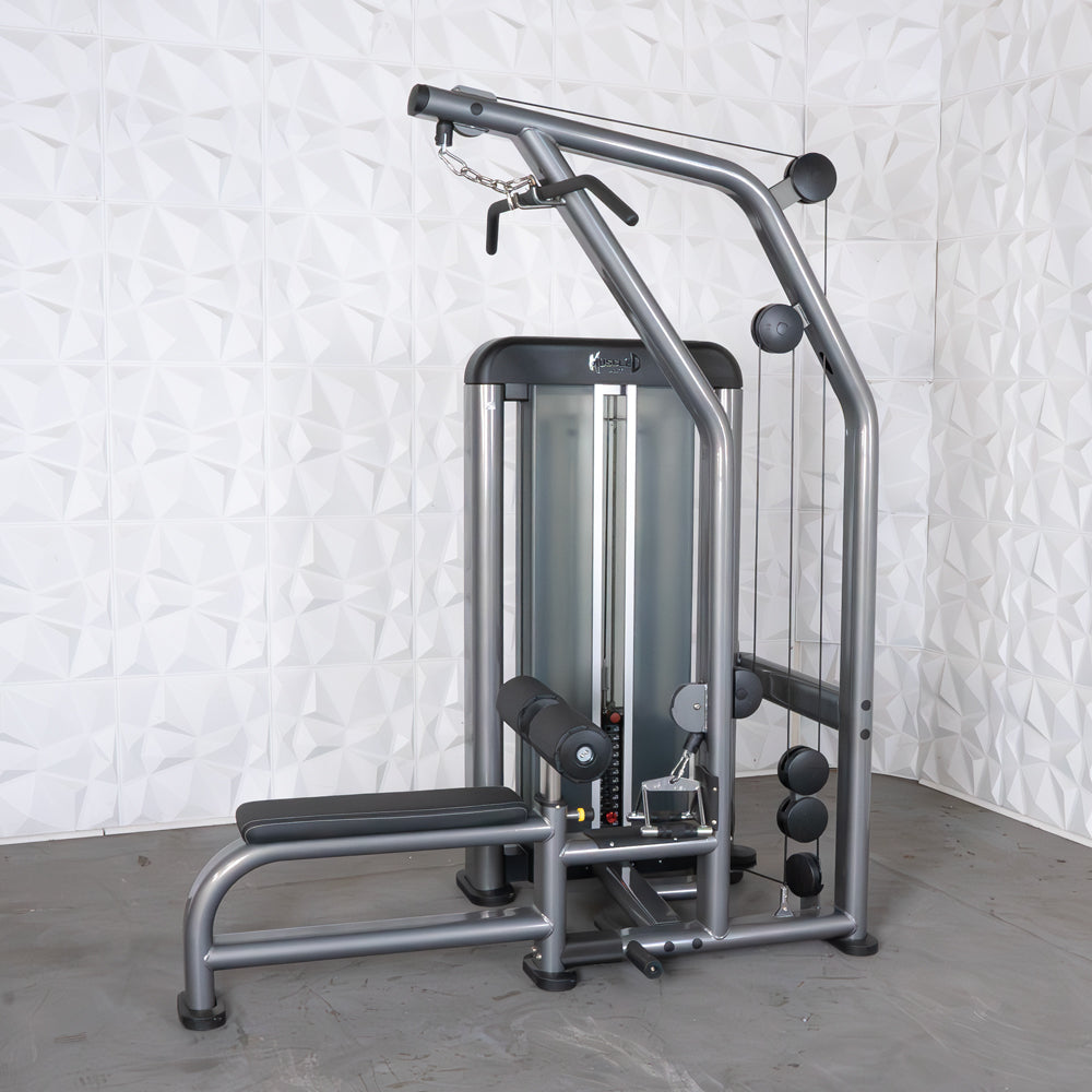 Gray commercial lat/low row machine with black padded seat and leg roller, pin selectorized weight stack.