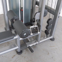 Thumbnail for Close-up of a gray lat/low row machine with black padded rollers, a seat, and a weight stack.