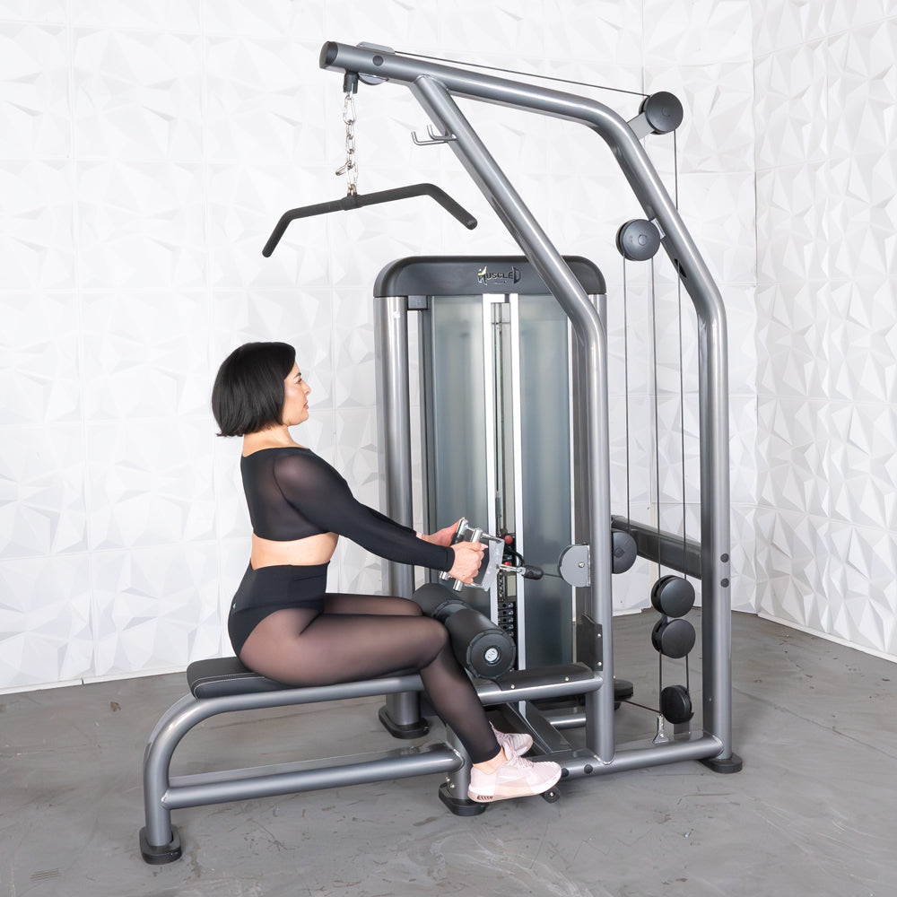 Woman using a grey lat pulldown and low row machine with a pin selectorized weight stack.
