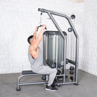 Thumbnail for Man using a gray lat pulldown machine with a weight stack and black seat.