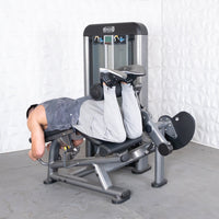 Thumbnail for Man using a leg extension curl combo machine, lying face down and curling his legs.