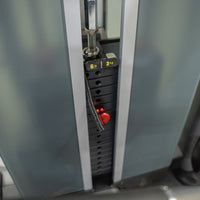Thumbnail for Close-up of a gym machine's weight stack, showing a red pin set at 6 lbs / 3 kg.