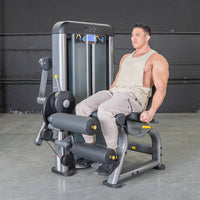 Thumbnail for Man using a grey leg extension and curl combo machine with black padding and yellow accents.