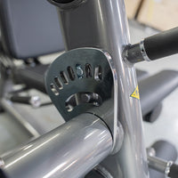 Thumbnail for Close-up of the silver adjustment plate and pin on a leg extension machine.