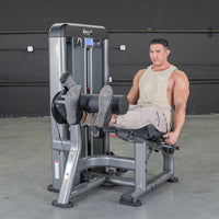 Thumbnail for Man using a grey and black leg extension machine in a gym.