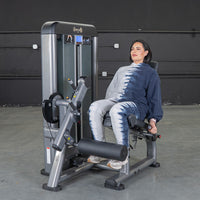 Thumbnail for Woman seated on a leg extension machine, ready to exercise.