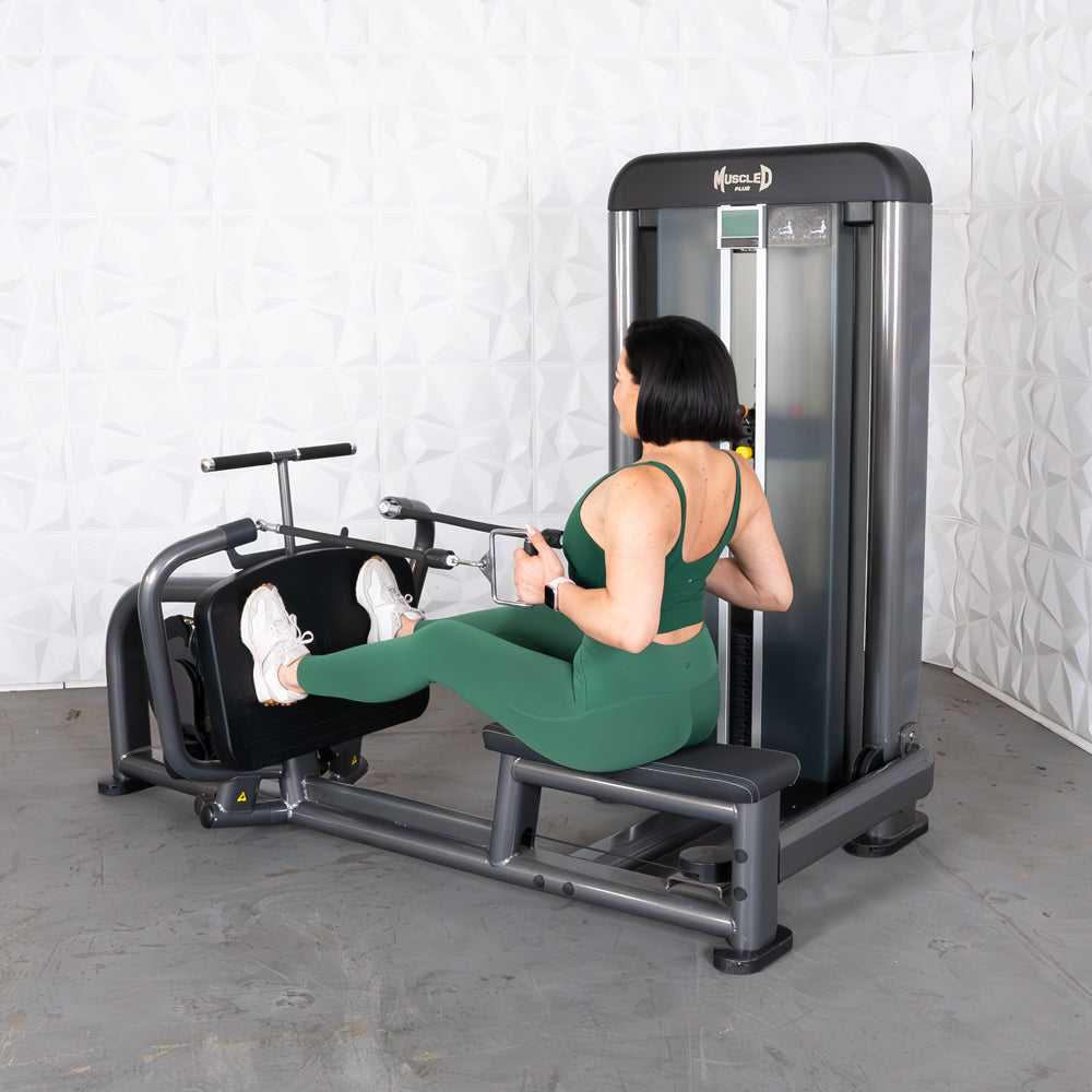Woman in green using an Elite Plus Long Pull Row machine.