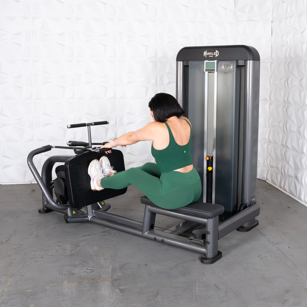 Woman in green performing a seated row exercise on a Muscle D Fitness machine.